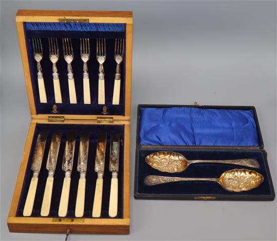 A cased set of six pairs of plated dessert eaters and a cased pair of plated berry spoons.